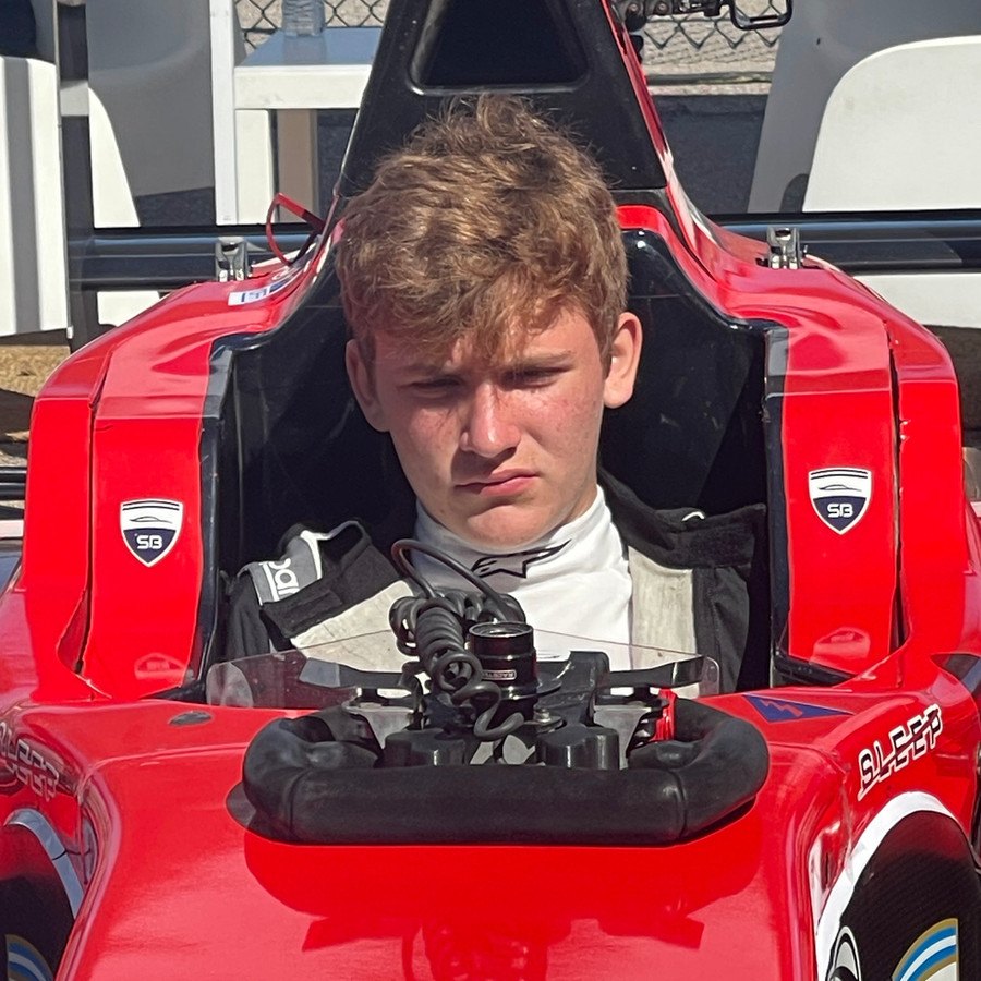 Rafal Wolosz seated in the cockpit of his single-seater, helmet off