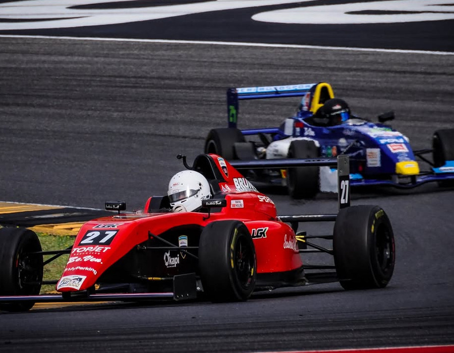 Rafal Wolosz racing wheel-to-wheel with a rival car on track