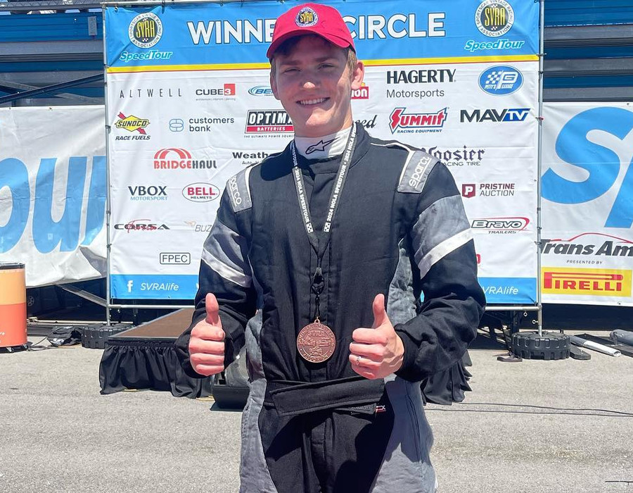 Rafal Wolosz celebrating in the winners circle with his medal