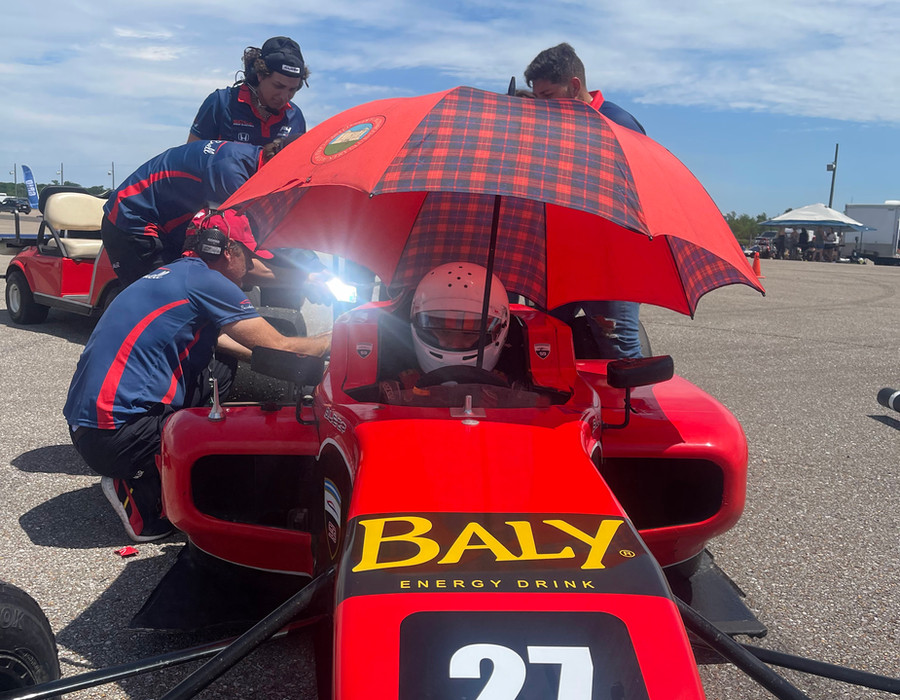 The crew working on the #27 car in the paddock between sessions